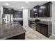 Kitchen boasts dark cabinetry, granite countertops, and stainless steel appliances perfect for the home chef at 6550 Devesta Loop, Palmetto, FL 34221