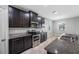 This kitchen features dark wood cabinetry, stainless steel appliances, and granite countertops, ideal for cooking at 6550 Devesta Loop, Palmetto, FL 34221