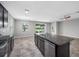 Open-concept kitchen with center island, stainless appliances, and granite countertops overlooks a lake view at 6550 Devesta Loop, Palmetto, FL 34221