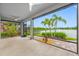 This lanai features ample space, a ceiling fan, and beautiful views of the water and backyard at 6550 Devesta Loop, Palmetto, FL 34221