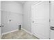 A tidy laundry room with tile flooring, wire shelving, and utility hookups at 6550 Devesta Loop, Palmetto, FL 34221