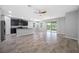 Open-concept living room with modern finishes, including granite countertops and lake views at 6550 Devesta Loop, Palmetto, FL 34221