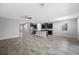 Open-concept living space featuring tile floors, a ceiling fan, and a modern kitchen with stainless steel appliances at 6550 Devesta Loop, Palmetto, FL 34221