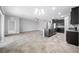 A spacious living room with an open kitchen features dark cabinets, granite countertops, and stainless steel appliances at 6550 Devesta Loop, Palmetto, FL 34221