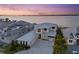 Aerial view of a waterfront home with a metal roof and stylish paver driveway at 676 Regatta Way, Bradenton, FL 34208