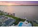 Breathtaking aerial view of waterfront property with private dock and a sparkling swimming pool at 676 Regatta Way, Bradenton, FL 34208
