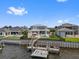 Waterfront home featuring a backyard pool, expansive lawn, and private boat dock at 676 Regatta Way, Bradenton, FL 34208