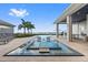Beautiful backyard featuring a modern pool with lounging area and waterfront views at 676 Regatta Way, Bradenton, FL 34208