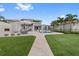 Beautiful backyard features an outdoor fireplace, patio, artificial turf, and a pool at 676 Regatta Way, Bradenton, FL 34208
