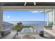 Enjoy the stunning water view from this stylish balcony with a swing, seating, and luxury finishes at 676 Regatta Way, Bradenton, FL 34208