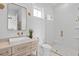Modern bathroom with a white sink, white cabinetry, and a frameless glass shower door at 676 Regatta Way, Bradenton, FL 34208