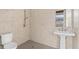Neutral colored bathroom featuring tiled shower, tiled floor, and pedestal sink at 676 Regatta Way, Bradenton, FL 34208