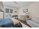 Stylish bedroom with a foosball table, hardwood floors, and comfortable sitting area with natural light at 676 Regatta Way, Bradenton, FL 34208