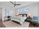 Modern bedroom featuring a geometric accent wall, modern furniture, and plenty of natural light at 676 Regatta Way, Bradenton, FL 34208