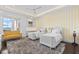 Bright bedroom showcasing two beds, a yellow loveseat, waterfront view, and a gray shag rug at 676 Regatta Way, Bradenton, FL 34208