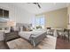 Tranquil bedroom featuring a comfortable bed, large windows, and a small table with seating at 676 Regatta Way, Bradenton, FL 34208