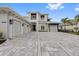 Stunning home featuring a three-car garage and elegant gray paver driveway at 676 Regatta Way, Bradenton, FL 34208