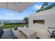 Inviting outdoor fireplace with comfortable seating, set against a beautiful waterfront view at 676 Regatta Way, Bradenton, FL 34208