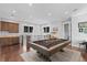 Second-floor game room with pool table, wet bar, hardwood floors, and plenty of natural light at 676 Regatta Way, Bradenton, FL 34208