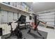 Home gym with exercise equipment and open garage door at 676 Regatta Way, Bradenton, FL 34208