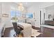 Stylish home office with modern desk, chandelier lighting, and large window with natural light at 676 Regatta Way, Bradenton, FL 34208