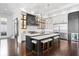 Modern kitchen with center island, seating, and open floor plan at 676 Regatta Way, Bradenton, FL 34208