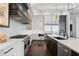 Modern kitchen with stainless steel appliances, a large island, and a stylish chandelier at 676 Regatta Way, Bradenton, FL 34208