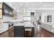 Open-concept kitchen and living room with an island and stainless steel appliances, perfect for entertaining at 676 Regatta Way, Bradenton, FL 34208