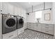 Convenient laundry room with modern appliances and stylish flooring at 676 Regatta Way, Bradenton, FL 34208