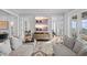 Cozy living room featuring comfortable gray sofas, decorative rug, hardwood floors, and plenty of natural light at 676 Regatta Way, Bradenton, FL 34208