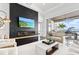 Inviting living room showcasing a fireplace, water views, and access to an outdoor patio at 676 Regatta Way, Bradenton, FL 34208