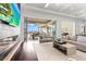 Bright living room featuring hardwood floors and sliding glass doors to outdoor patio at 676 Regatta Way, Bradenton, FL 34208
