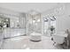 Luxurious bathroom with freestanding tub, glass shower, dual vanity and marble flooring at 676 Regatta Way, Bradenton, FL 34208