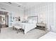 Stylish bedroom features decorative wall trim, light neutral tones, and modern light fixtures at 676 Regatta Way, Bradenton, FL 34208