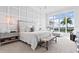 Beautiful bedroom features large windows with water views, decorative wall trim and lighting at 676 Regatta Way, Bradenton, FL 34208
