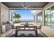 Covered outdoor dining area with a grill and stunning water views at 676 Regatta Way, Bradenton, FL 34208