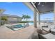 Upscale patio with large pool, spa, and outdoor seating, all overlooking the waterway at 676 Regatta Way, Bradenton, FL 34208