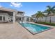 Spacious backyard with a sparkling pool and comfortable lounge areas, great for entertaining at 676 Regatta Way, Bradenton, FL 34208