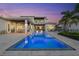 Beautiful pool with a shimmering water feature, perfect for evening relaxation at 676 Regatta Way, Bradenton, FL 34208