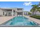Resort-style pool with a sun shelf, lounge chairs, and lush landscaping at 676 Regatta Way, Bradenton, FL 34208