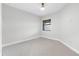 Bright bedroom features neutral carpet, a window, and a ceiling fan at 7661 Summerland Cv, Bradenton, FL 34202