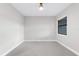Bright bedroom features neutral carpet and a window at 7661 Summerland Cv, Bradenton, FL 34202