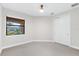 Bedroom features neutral carpet, a window, and a closet at 7661 Summerland Cv, Bradenton, FL 34202