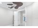 Bedroom with ceiling fan and view of hallway at 7661 Summerland Cv, Bradenton, FL 34202