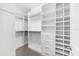 A custom closet featuring adjustable shelving, drawers, and hanging rods at 7661 Summerland Cv, Bradenton, FL 34202