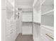 Walk-in closet with custom shelving and gold hardware at 7661 Summerland Cv, Bradenton, FL 34202