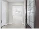 Bright foyer leading to an open-concept living space with modern chandelier lighting at 7661 Summerland Cv, Bradenton, FL 34202