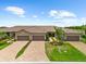 Stunning aerial view showcasing brick driveways, lush lawns, manicured landscaping, and the home's exterior at 7661 Summerland Cv, Bradenton, FL 34202