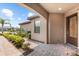 Inviting covered front porch with decorative brickwork and a stylish front door at 7661 Summerland Cv, Bradenton, FL 34202