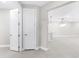 Bright hallway leading into a spacious living area with modern lighting fixtures at 7661 Summerland Cv, Bradenton, FL 34202